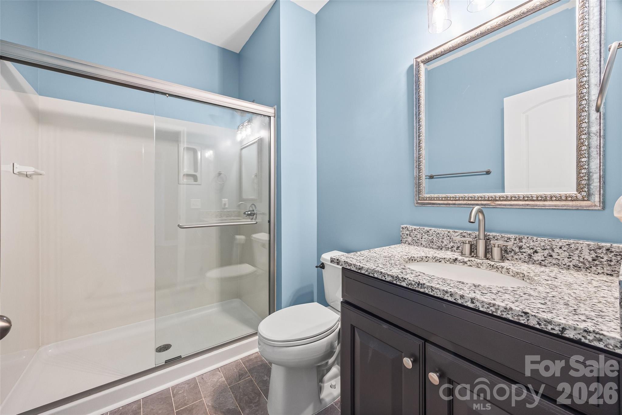 240 Loch Stone Street Fort Mill, SC 29715 - Photo 23 of 45 a bathroom with a granite countertop sink toilet and shower