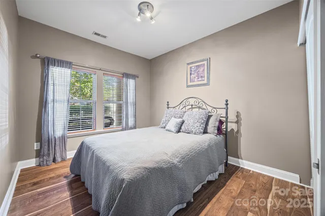 a bedroom with a bed and a large window