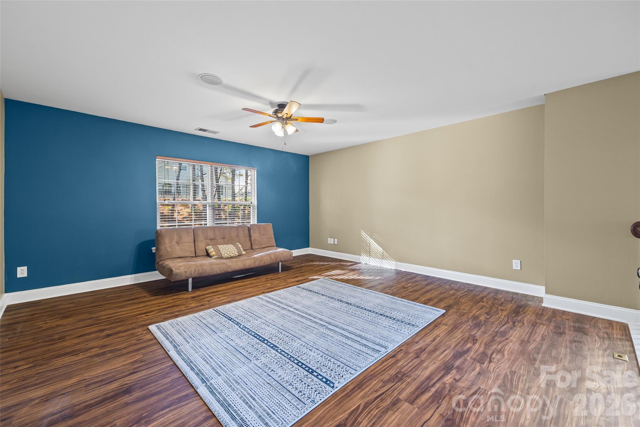 240 Loch Stone Street Fort Mill, SC 29715 - Photo 26 of 45 a living room with hard wood floors and a ceiling fan