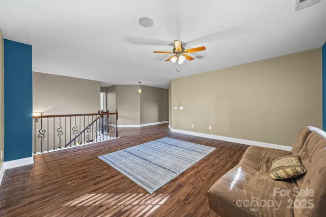 a view of a room with wooden floor and window