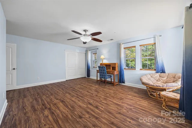 a bed room with a bed and a chair