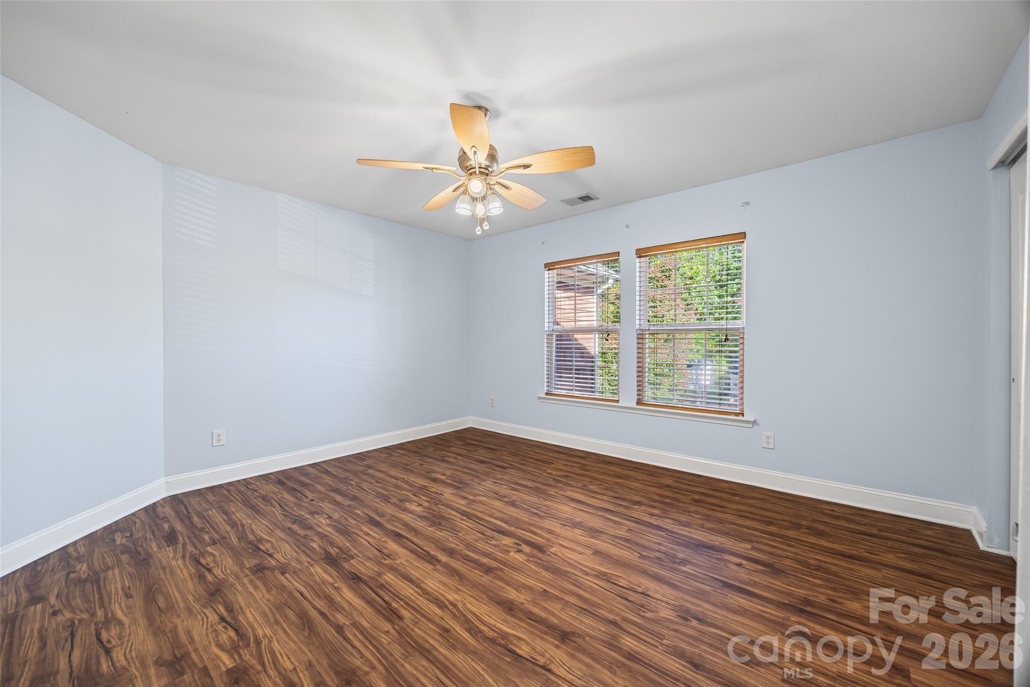 240 Loch Stone Street Fort Mill, SC 29715 - Photo 34 of 45 a view of a room with wooden floor and a ceiling fan