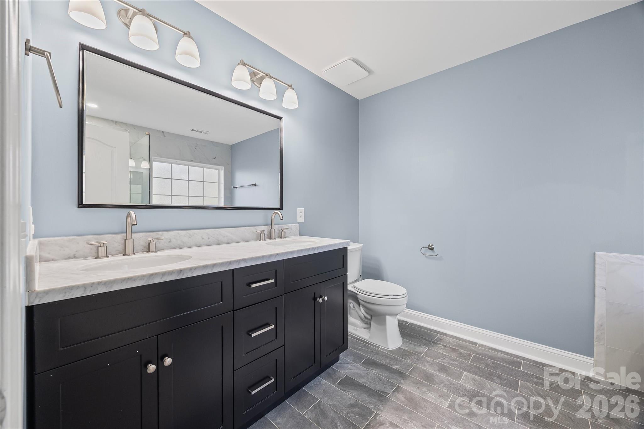240 Loch Stone Street Fort Mill, SC 29715 - Photo 39 of 45 a bathroom with a toilet sink and mirror