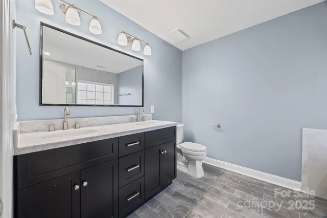 a bathroom with a toilet sink and mirror