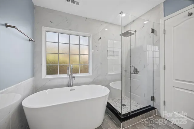 a white bath tub sitting next to a shower