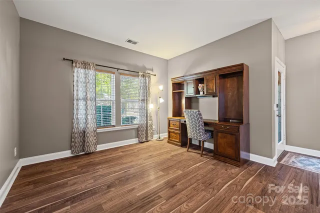 a view of room with window and wooden floor