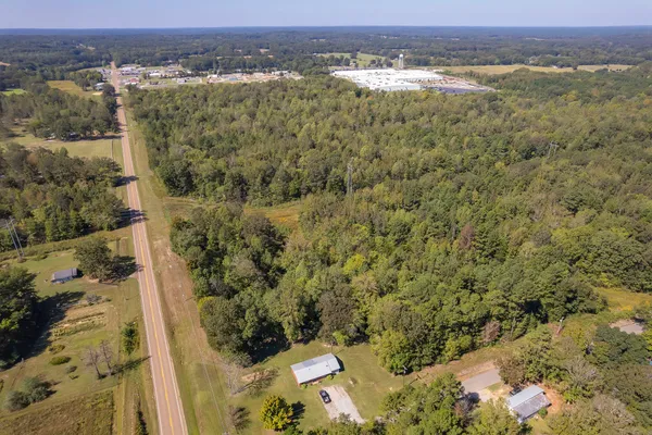 an aerial view of a houses with a yard