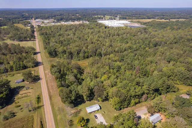 an aerial view of a houses with a yard