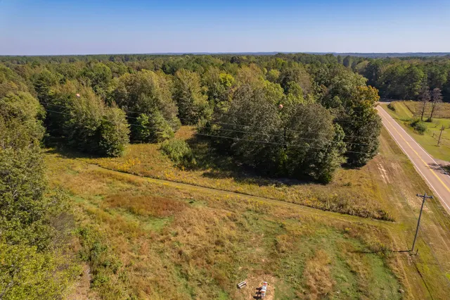 a view of a yard with wooden fence