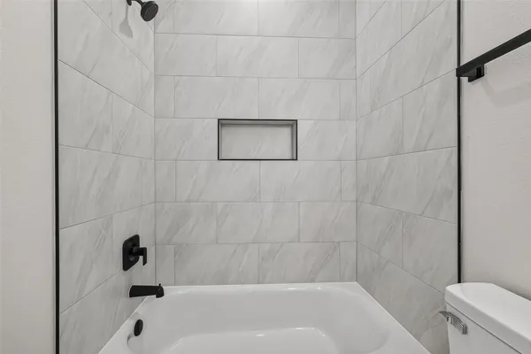 a bathroom with a bathtub and a toilet