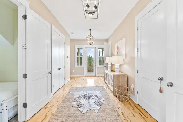 a large white kitchen with a large window