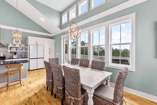 a view of a dining room with furniture large windows and wooden floor