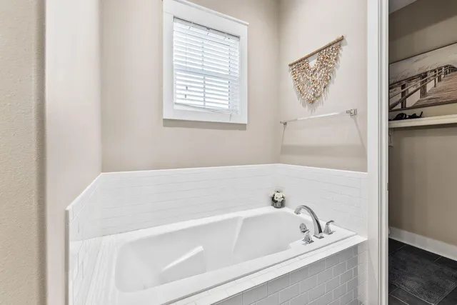 a white bath tub sitting next to a window