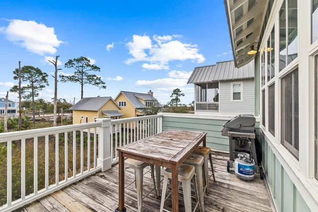 a view of a chairs and table in the balcony