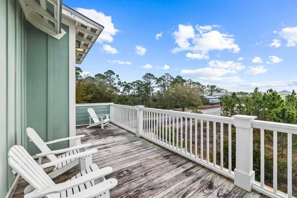 a view of balcony with wooden floor and outdoor seating