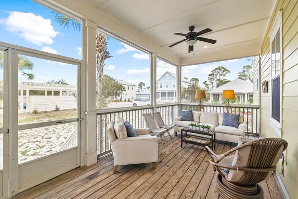 a living room with furniture and a floor to ceiling window