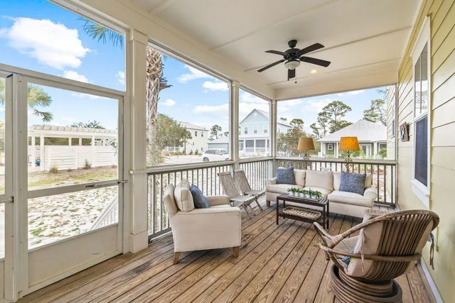 a living room with furniture and a floor to ceiling window