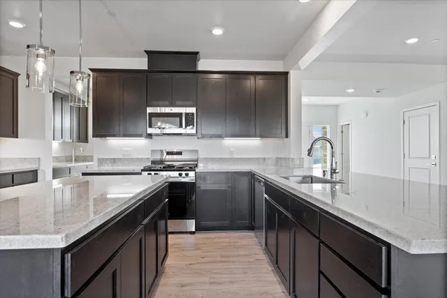 a large kitchen with stainless steel appliances kitchen island granite countertop a large counter top stainless steel appliances and cabinets