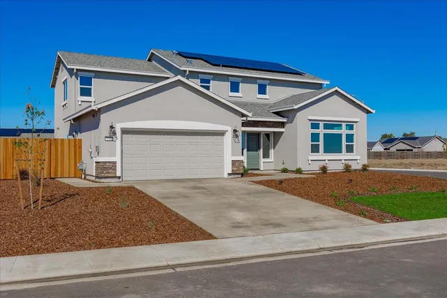 a front view of a house with garage