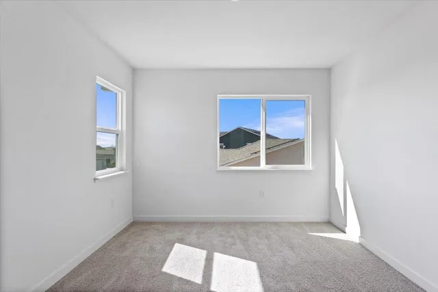 a view of a grassy field with ocean view