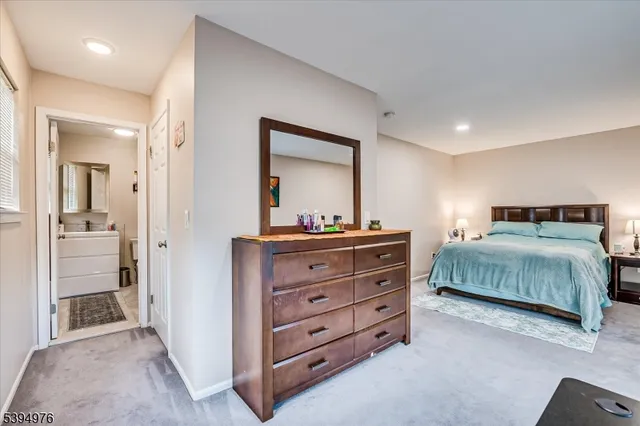 a bedroom with a bed and a mirror