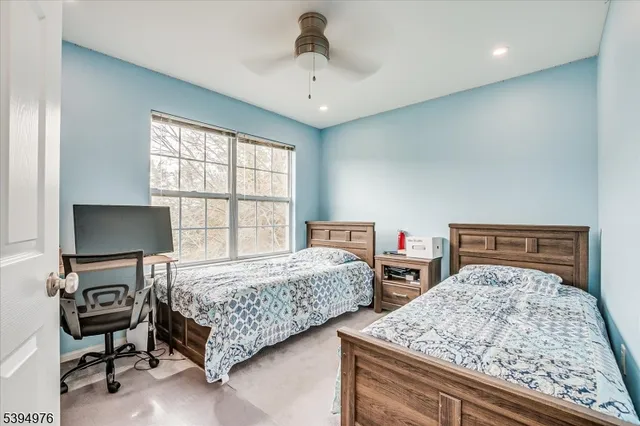 a bedroom with two beds and a flat screen tv