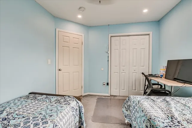 a bedroom with a bed and a chair