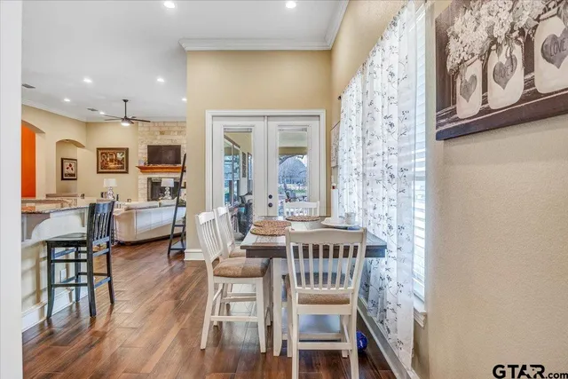 a bedroom with a bed wooden floor and a large window