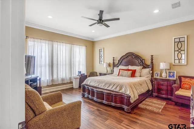 a en suite bathroom with a granite countertop sink and a mirror