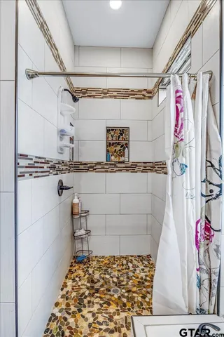 a bathroom with a granite countertop sink a toilet and shower