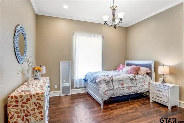 a bedroom with a large bed and a flat screen tv