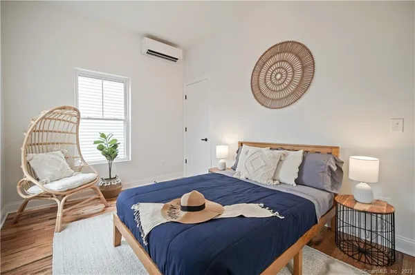 a bedroom with a bed and chair