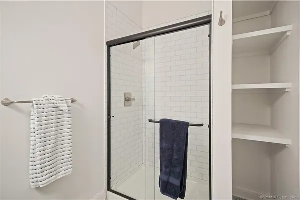 a bathroom with a shower and a mirror