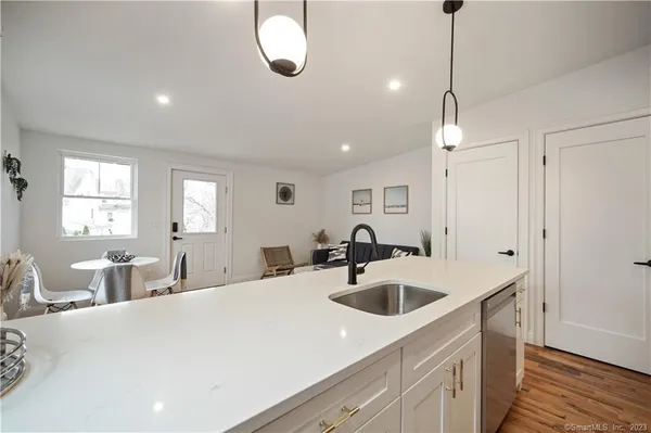 a kitchen with sink a faucet and chairs