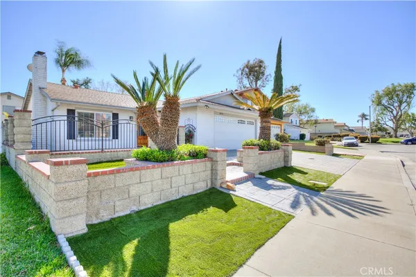a view of a house with swimming pool and a yard