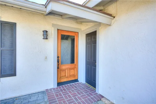 an empty room with wooden floor a fireplace and windows