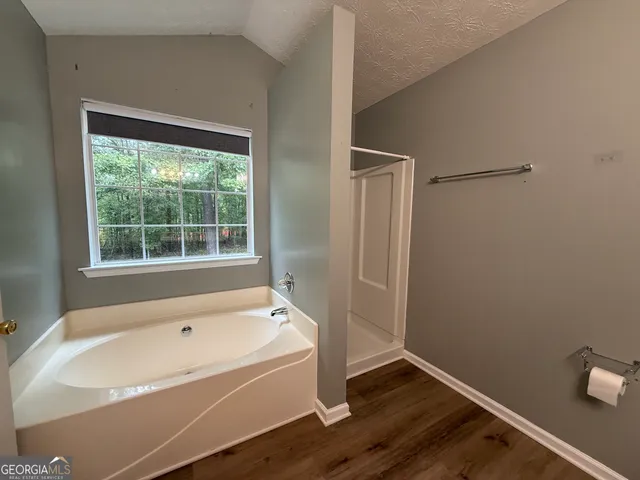 a bathroom with a bathtub and a window