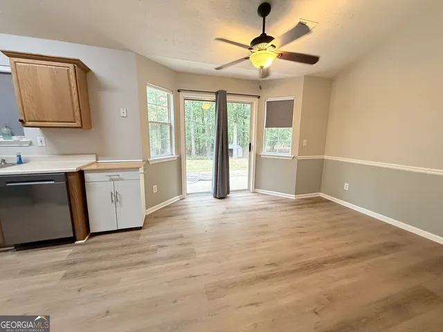 a view of a kitchen with a sink and cabinet area