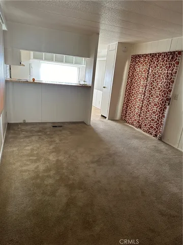 a view of room with window and cabinets