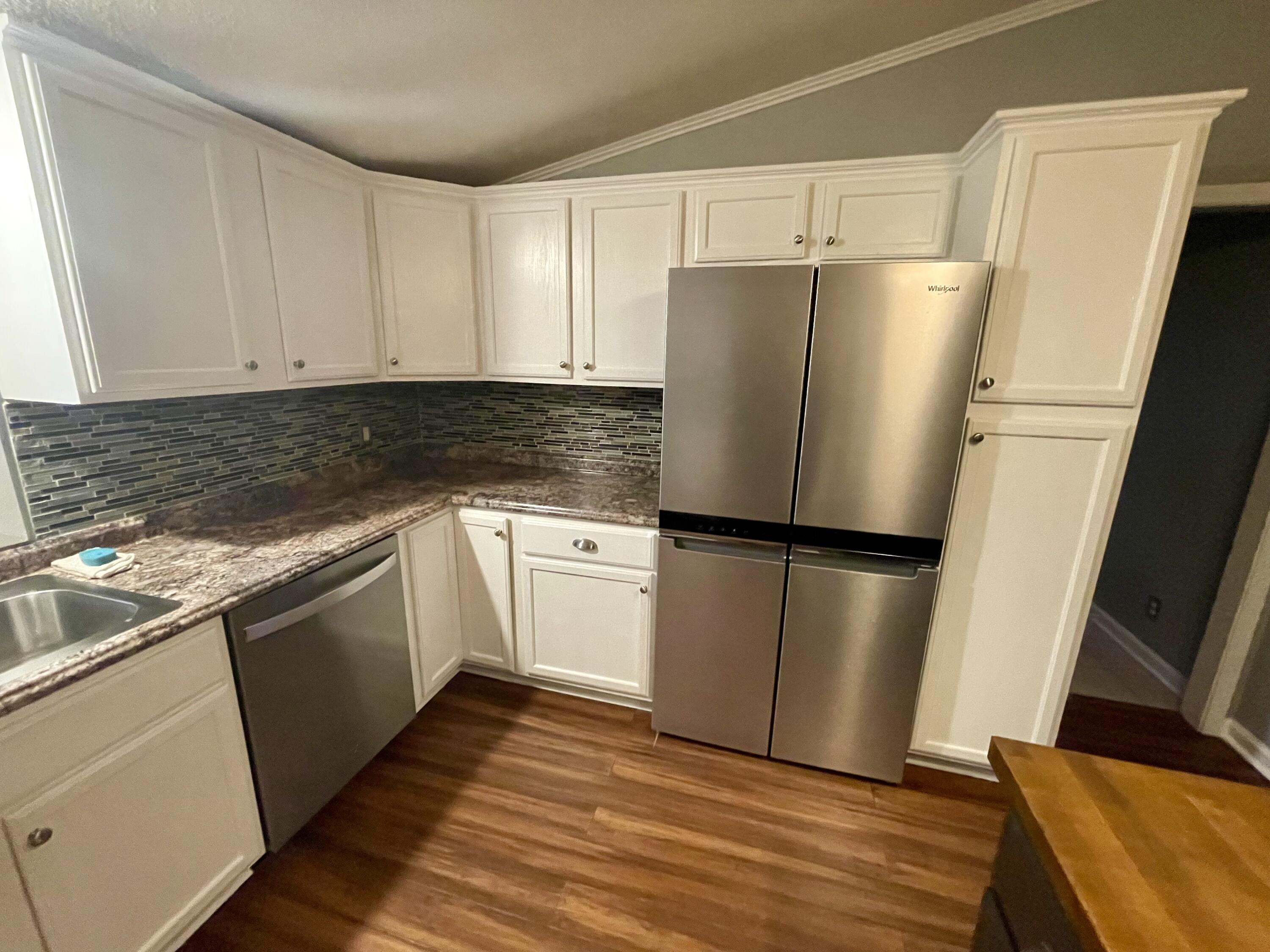 2143 Deep Woods Road Hardy, VA 24101 - Photo 6 of 27 a kitchen with a refrigerator sink and cabinets