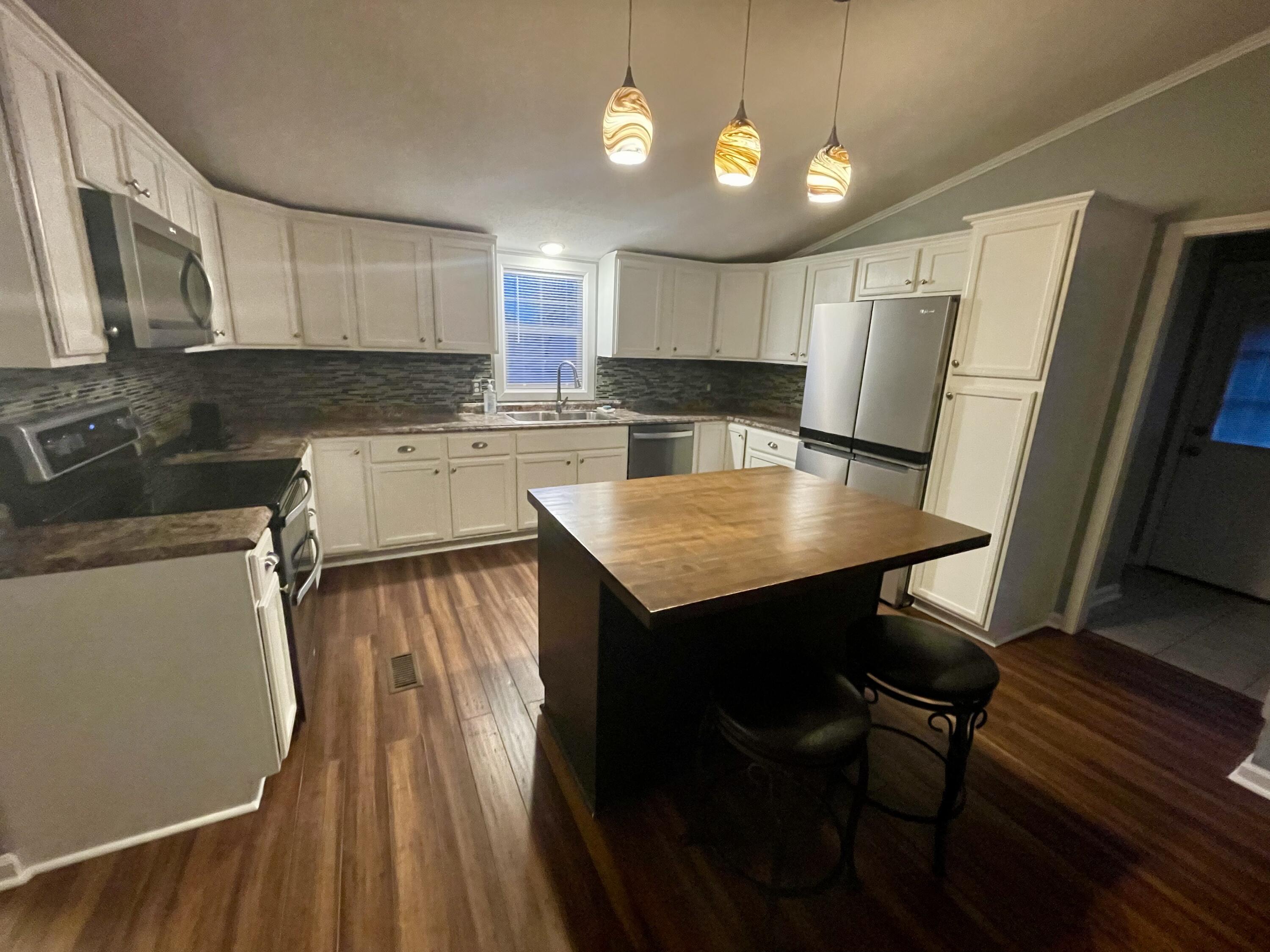 2143 Deep Woods Road Hardy, VA 24101 - Photo 7 of 27 a kitchen with a table chairs refrigerator and microwave
