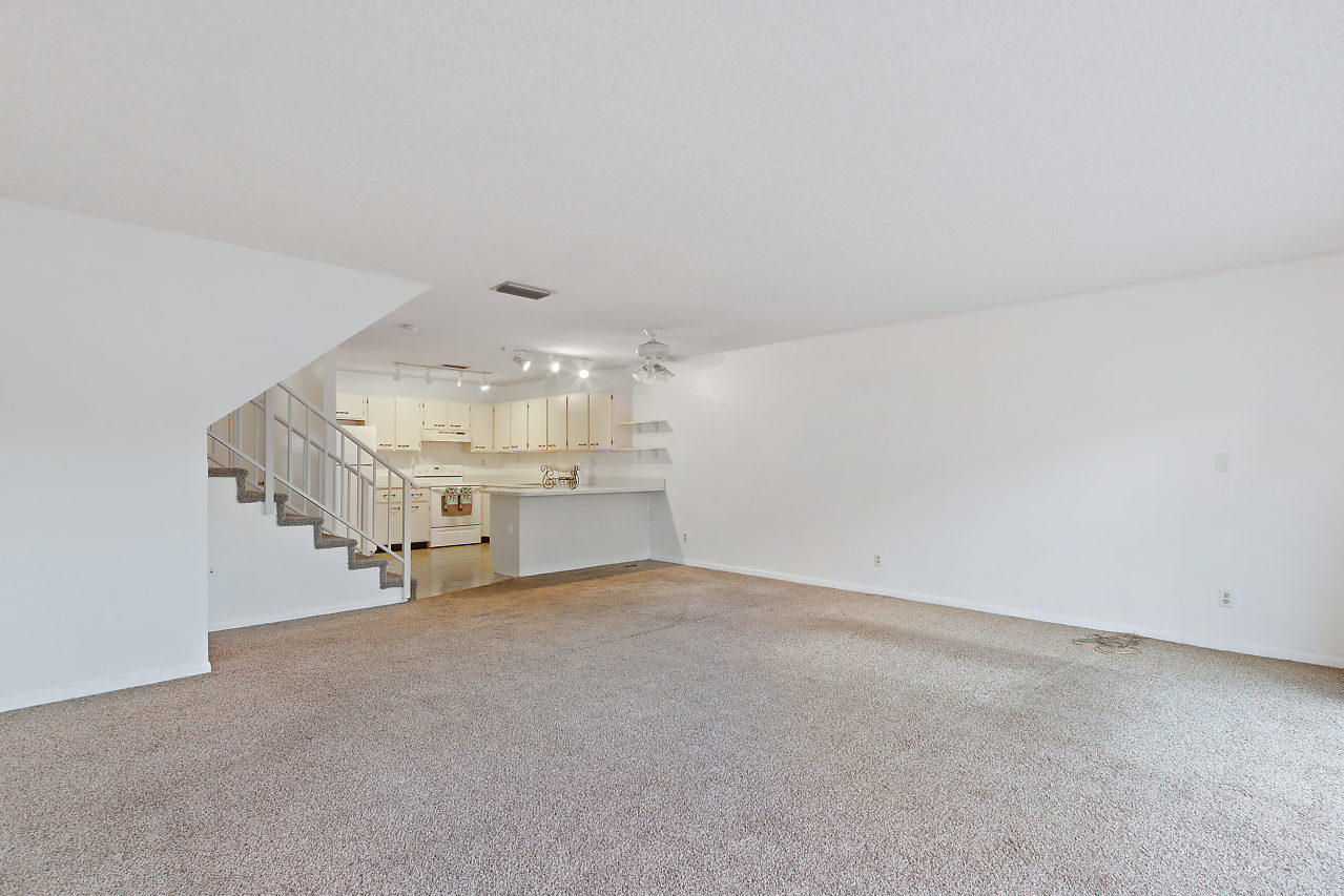 8815 Southwest 21st Street, Unit D Boca Raton, FL 33433 - Photo 11 of 27 an empty room with a empty space and windows