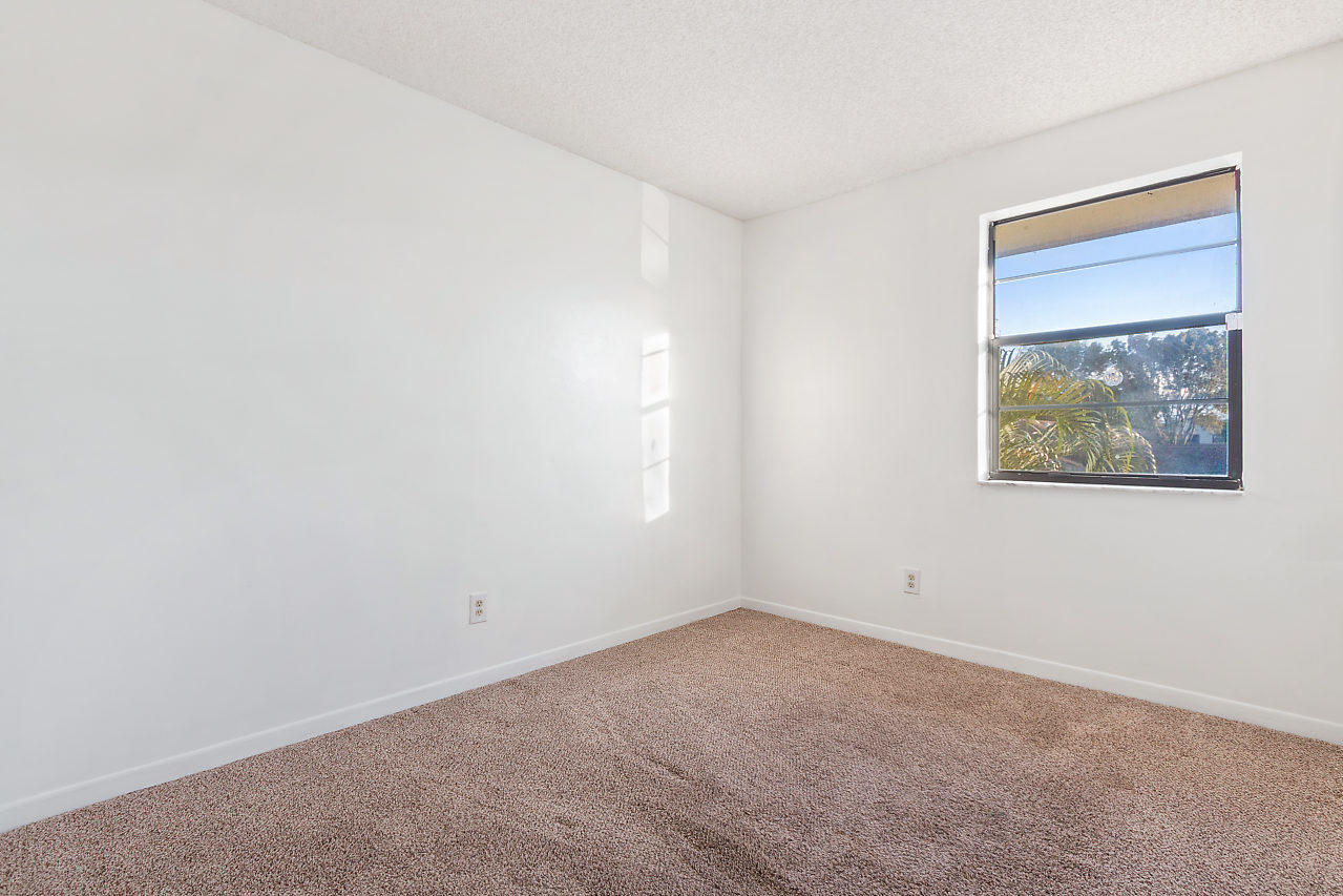 8815 Southwest 21st Street, Unit D Boca Raton, FL 33433 - Photo 13 of 27 an empty room with a window