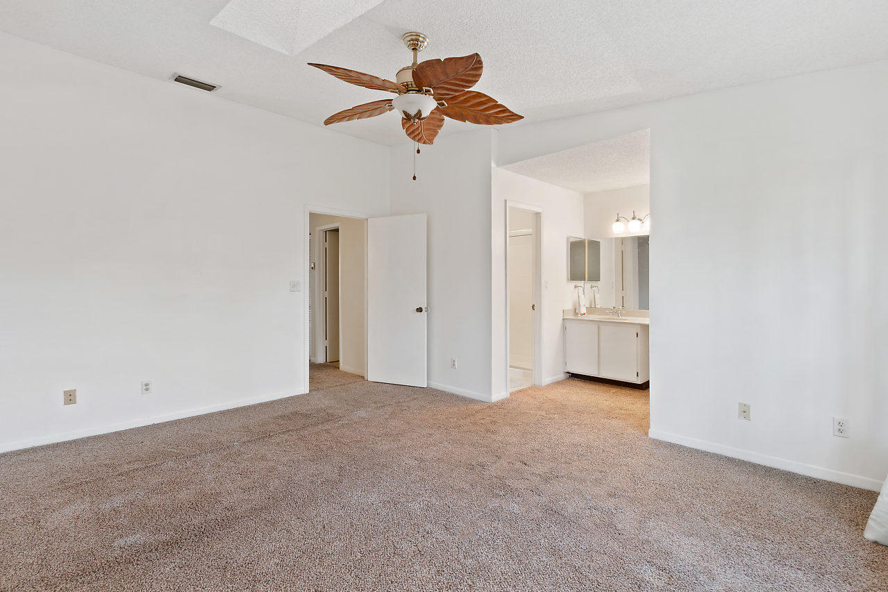 8815 Southwest 21st Street, Unit D Boca Raton, FL 33433 - Photo 17 of 27 an empty room with a ceiling fan and a window