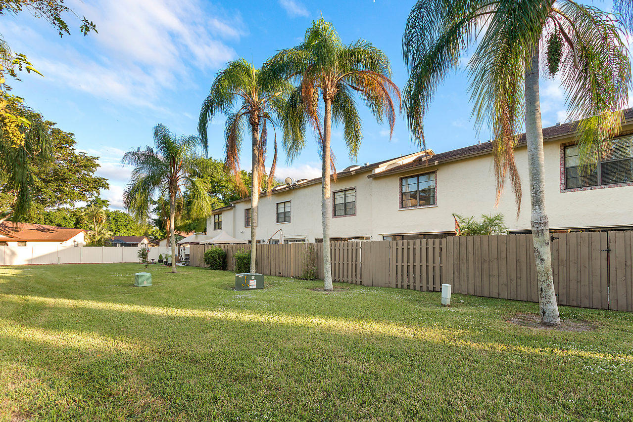 8815 Southwest 21st Street, Unit D Boca Raton, FL 33433 - Photo 24 of 27 a view of a house with a yard