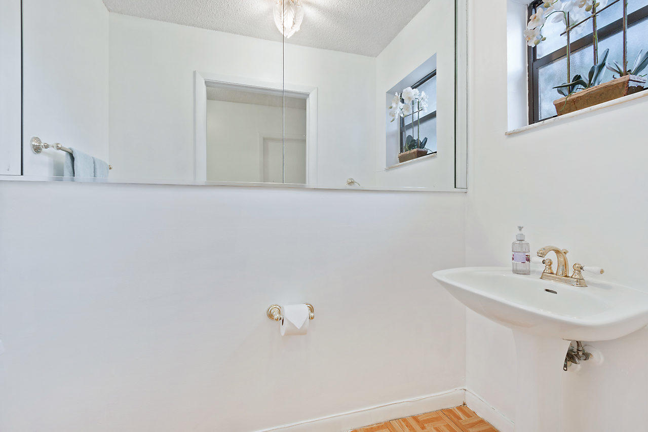 8815 Southwest 21st Street, Unit D Boca Raton, FL 33433 - Photo 5 of 27 a bathroom with a sink and a mirror