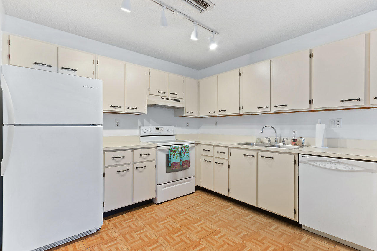 8815 Southwest 21st Street, Unit D Boca Raton, FL 33433 - Photo 6 of 27 a kitchen with cabinets appliances a sink and a counter space