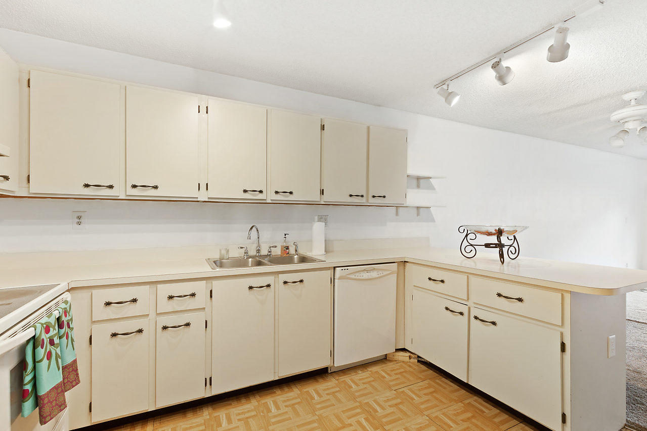 8815 Southwest 21st Street, Unit D Boca Raton, FL 33433 - Photo 7 of 27 a kitchen with white cabinets and white appliances