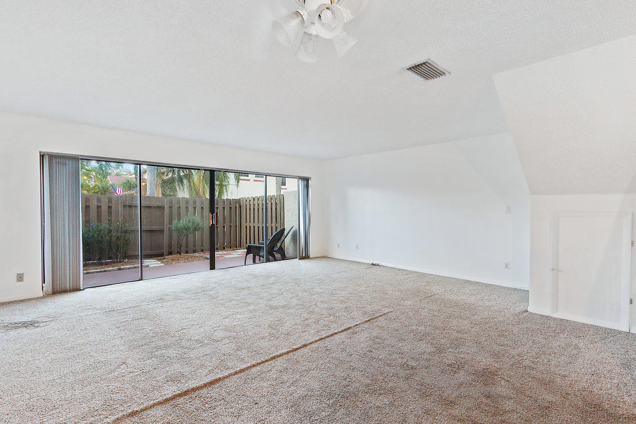 8815 Southwest 21st Street, Unit D Boca Raton, FL 33433 - Photo 10 of 27 a view of an empty room with glass door