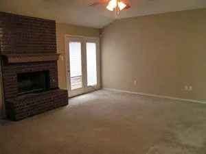 a view of an empty room with a fireplace